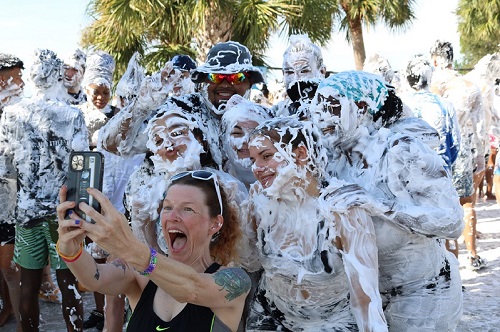 Students pictured in group covered in shaving cream, smiling