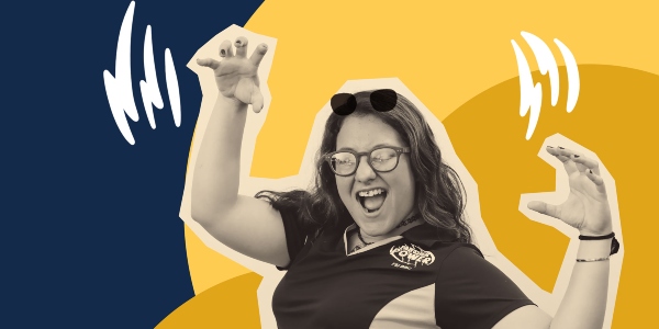 A student holding her hands up in the shape of claws to show her FIU Panther pride.
