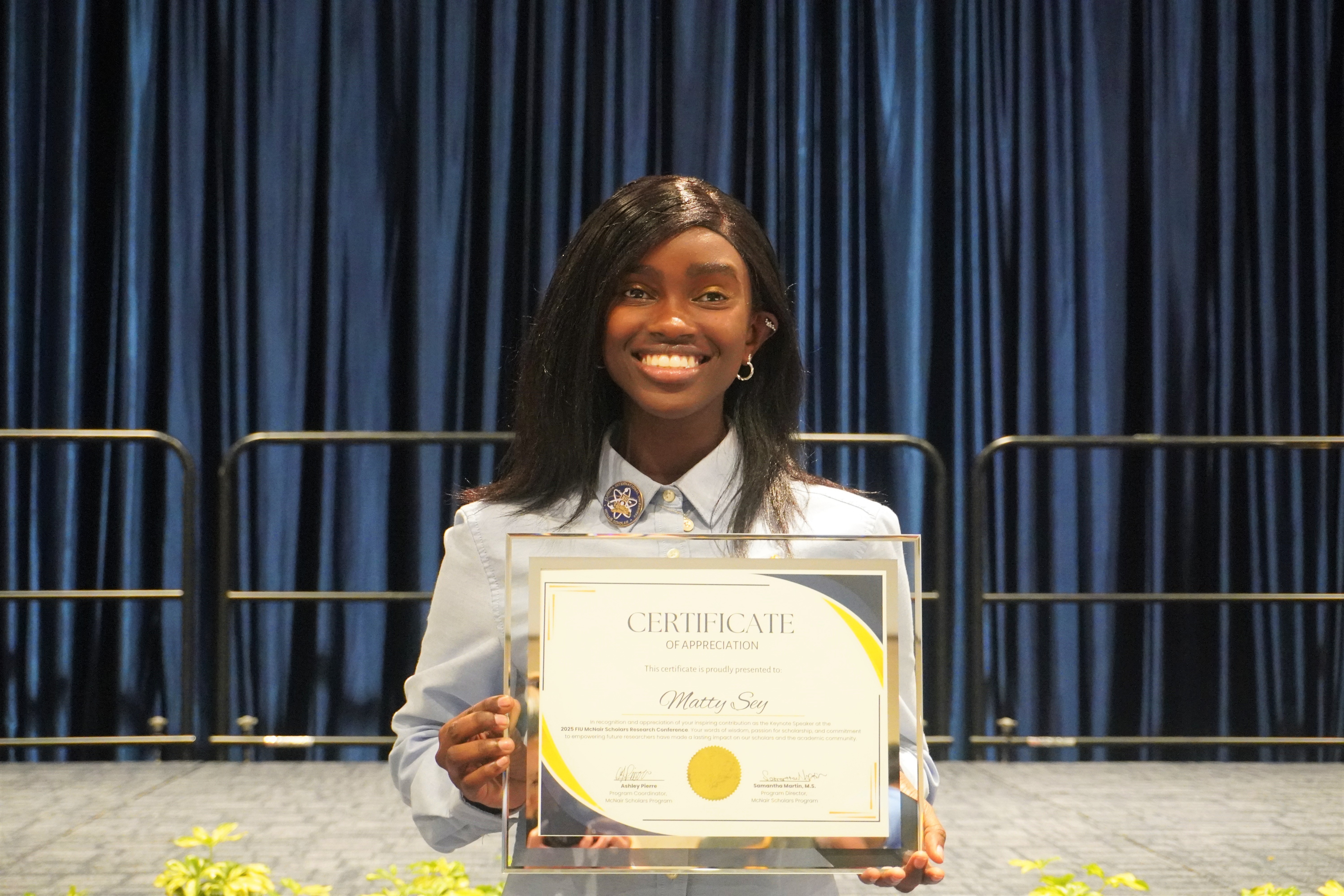 image of Matty Sey with certificate of appreciation